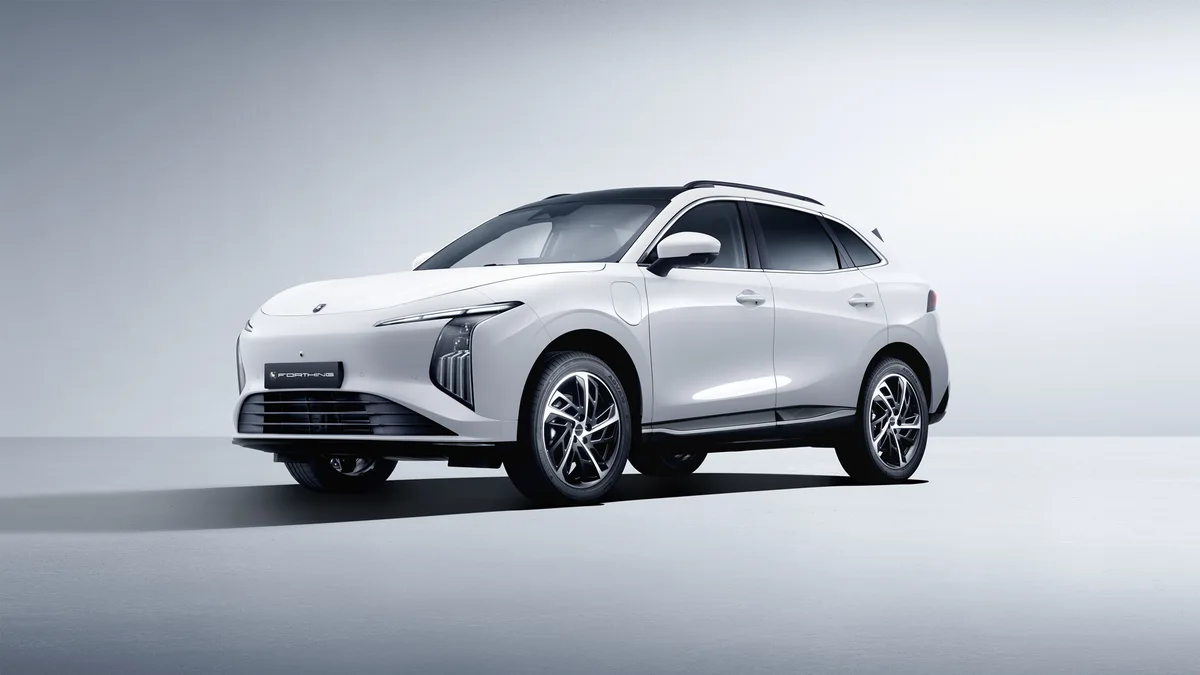 SUV eléctrico Forthing 5 BEV blanco, visto en perspectiva frontal de tres cuartos sobre un fondo gris claro.